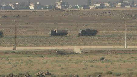 Vehicles are seen near Nasib border crossing between Jordan and Syria, Marafaq, Jordan, July 6, 2018, in this still image obtained from a video. REUTERS via Reuters TV
