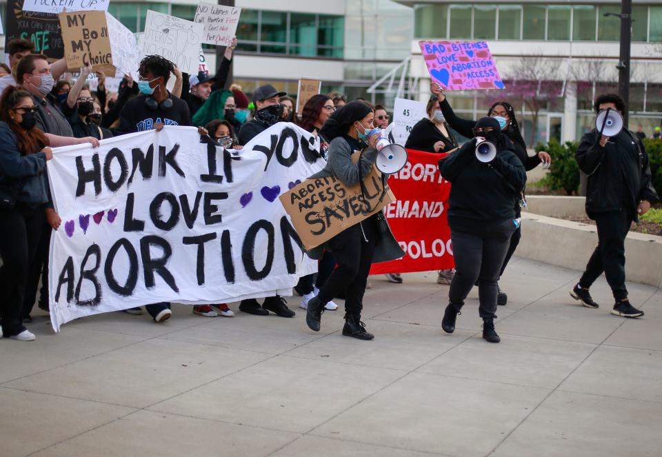 Protesters chant and hold signs in opposition to the U.S. Supreme Court's document outlining the repeal of Roe v. Wade during an Abort the State rally and march in downtown Des Moines on Wednesday, May 4, 2022.