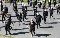 People dance to Jerusalema in Cape Town, South Africa, Thursday, Sept. 24, 2020. South Africans of all walks of life are dancing to “Jerusalema,” a rousing anthem to lift their spirits amid the battle against COVID-19. In response to a call from President Cyril Ramaphosa to mark the country’s Heritage Day holiday Thursday, people from townships to posh suburbs are doing line dances to the tune. (AP Photo/Nardus Engelbrecht)