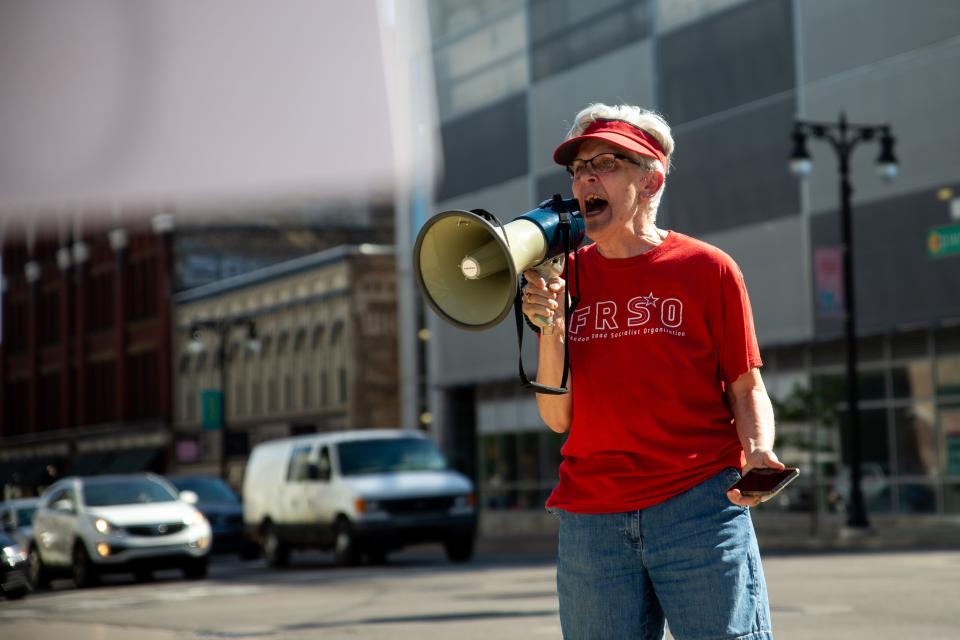 Barbara Howard, a member of the Freedom Road Socialist Organization, speaks to demonstrators as they protest the reversal of Roe v. Wade on Friday, June 24, at Monument Park in downtown Grand Rapids.