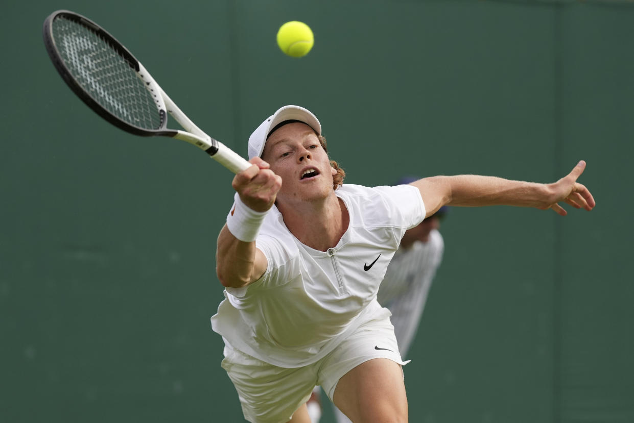 Italy's Jannik Sinner plays a return to Sweden's Mikael Ymer in a second round men's singles match on day three of the Wimbledon tennis championships in London, Wednesday June 29, 2022. (AP Photo/Alberto Pezzali)