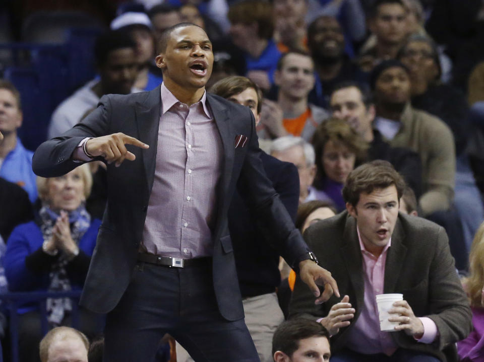 Oklahoma City Thunder guard Russell Westbrook cheers from the bench in the first quarter of an NBA basketball game against the Portland Trail Blazers in Oklahoma City, Tuesday, Jan. 21, 2014. (AP Photo/Sue Ogrocki)