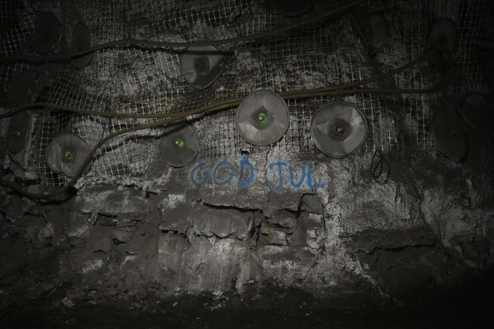 'Merry Christmas' is written on the wall in Norwegian at the bottom of the Gruve 7 coal mine in Adventdalen, Norway, Monday, Jan. 9, 2023. The last Norwegian coal mine in Svalbard – an archipelago that's one of the world's fastest warming spots – was slated to close this year and only got a reprieve until 2025 because of the energy crisis driven by the war in Ukraine. (AP Photo/Daniel Cole)