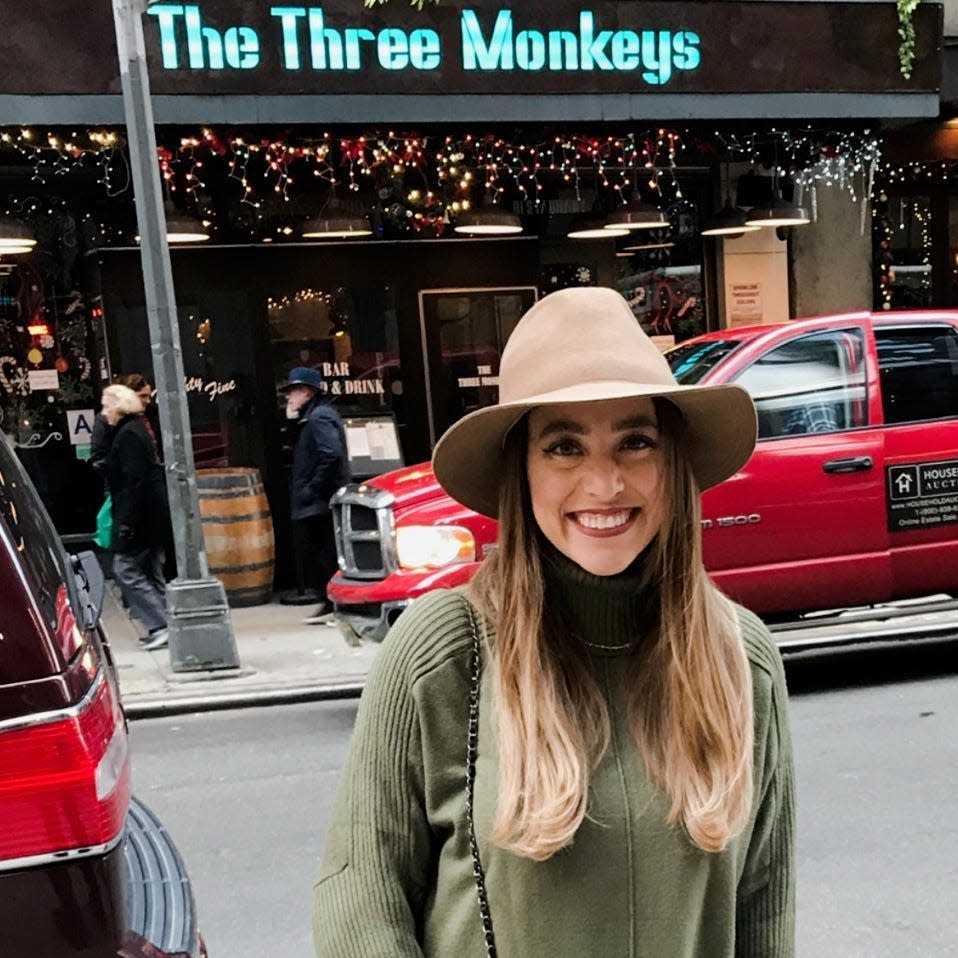 Brittany Williams in front of The Three Monkeys bar