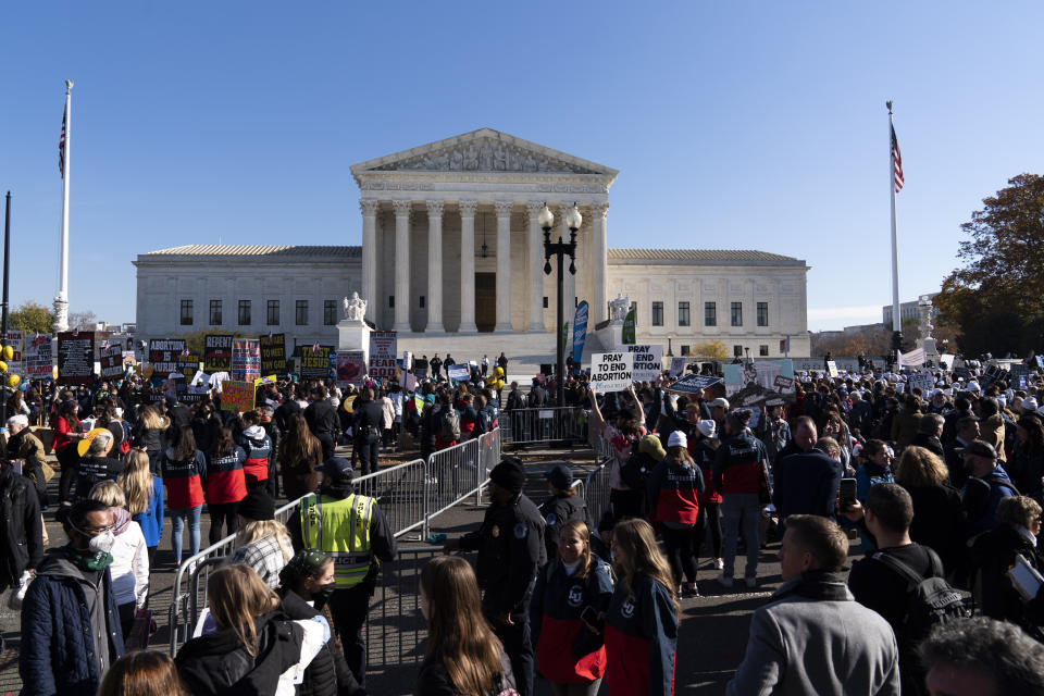 Anti-abortion and Abortion rights advocates demonstrate in front of the U.S. Supreme Court Wednesday, Dec. 1, 2021, in Washington, as the court hears arguments in a case from Mississippi, where a 2018 law would ban abortions after 15 weeks of pregnancy, well before viability. (AP Photo/Jose Luis Magana)