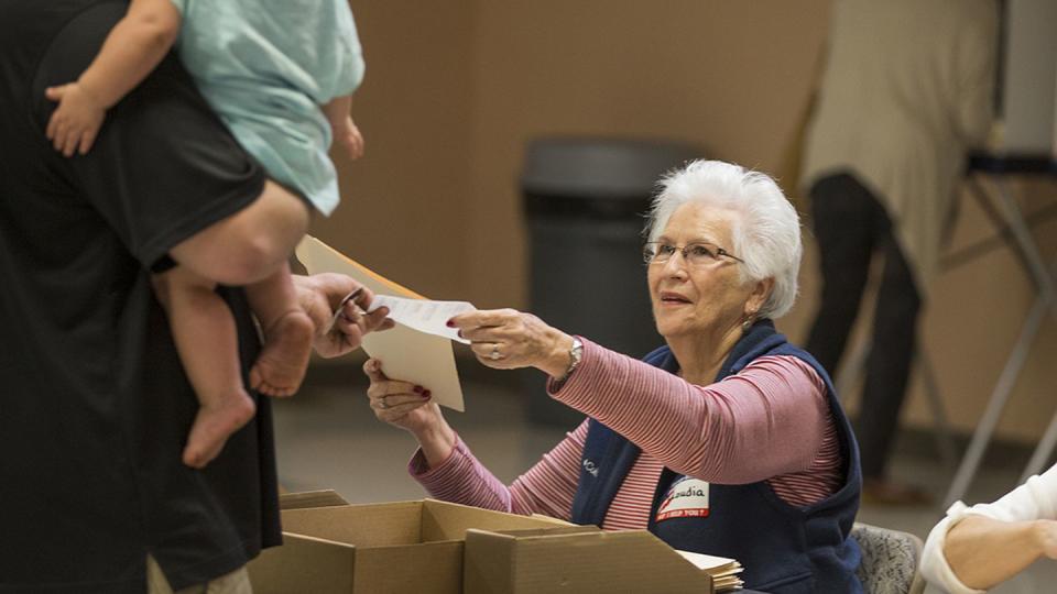 A poll worker in Tallahassee, Florida, hands a voter his ballot on Nov. 8, 2016. (Mark Wallheiser/Getty Images)