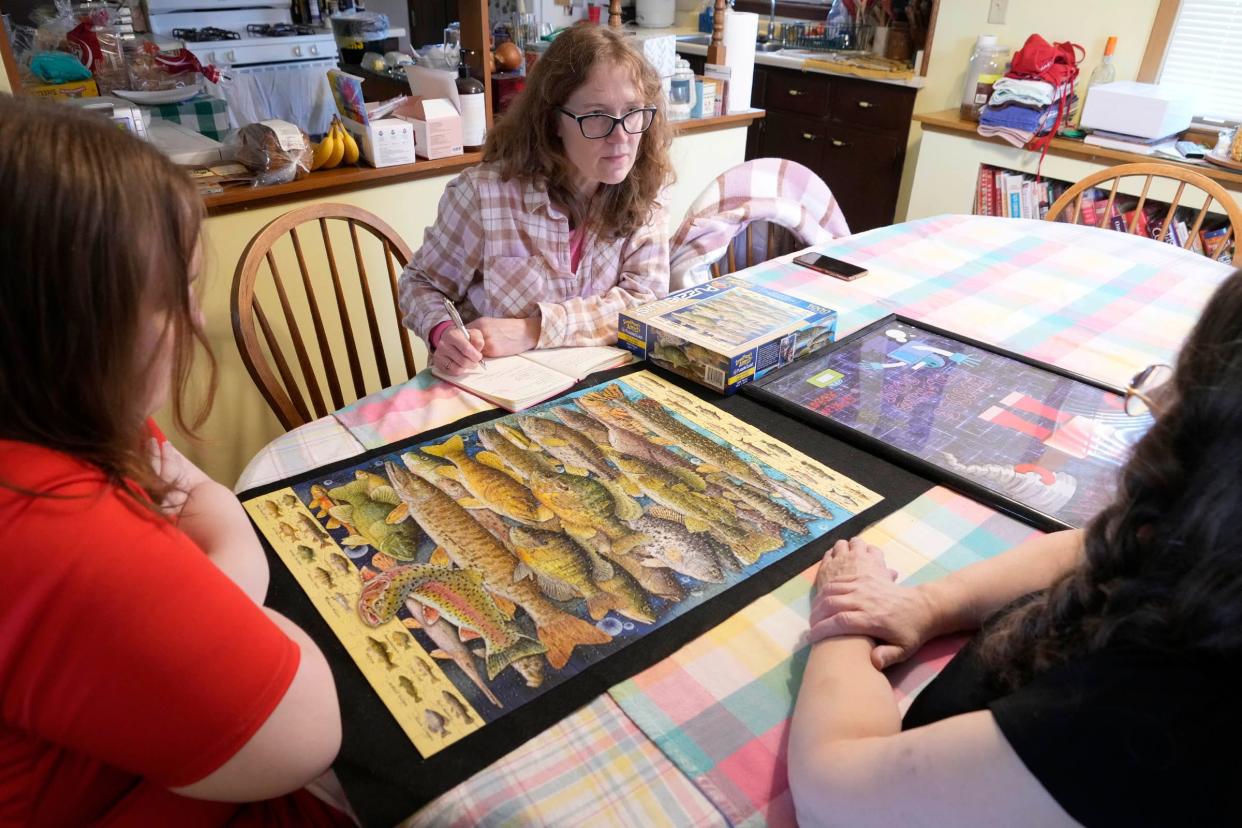 Reporter Amy Schwabe (center) talks with Alison Peetz and her son, Ben, for a story in the Kids in Crisis series.