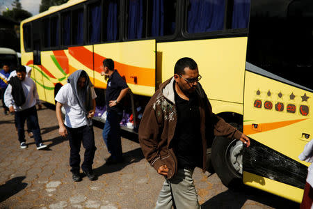 Deportees get off a bus at an immigration facility after a flight carrying illegal immigrants from the U.S. arrived in San Salvador, El Salvador, January 11, 2018. Picture taken January 11, 2018. REUTERS/Jose Cabezas