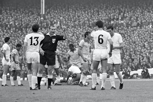 Pele (on floor) receives treatment from trainer Americo (kneeling) as referee Kurt Tschenscher (second left) warns Bulgaria’s Dimitar Yakimov (13) and Dobromir Jetchev (6) (PA)