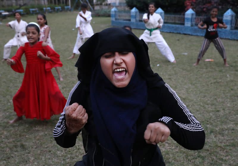 Woman reacts as she practices a self-defense technique at a training camp in Kolkata