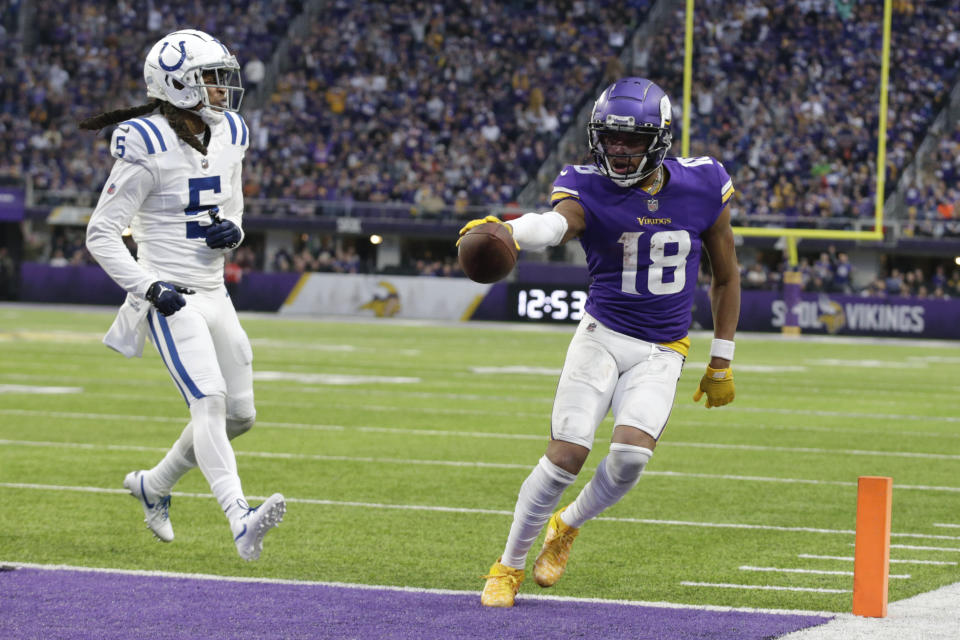 FILE - Minnesota Vikings wide receiver Justin Jefferson (18) scores on an 8-yard touchdown reception next to Indianapolis Colts cornerback Stephon Gilmore (5) during the second half of an NFL football game Dec. 17, 2022, in Minneapolis. Jalen Hurts, Jefferson and Patrick Mahomes are finalists for The Associated Press 2022 NFL Most Valuable Player and Offensive Player of the Year awards. (AP Photo/Andy Clayton-King, File)