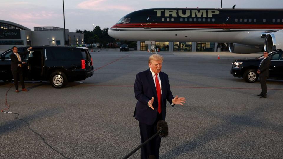 PHOTO: Former President Donald Trump speaks to the media at Atlanta Hartsfield-Jackson International Airport after surrendering at the Fulton County jail on Aug. 24, 2023 in Atlanta. (Joe Raedle/Getty Images)