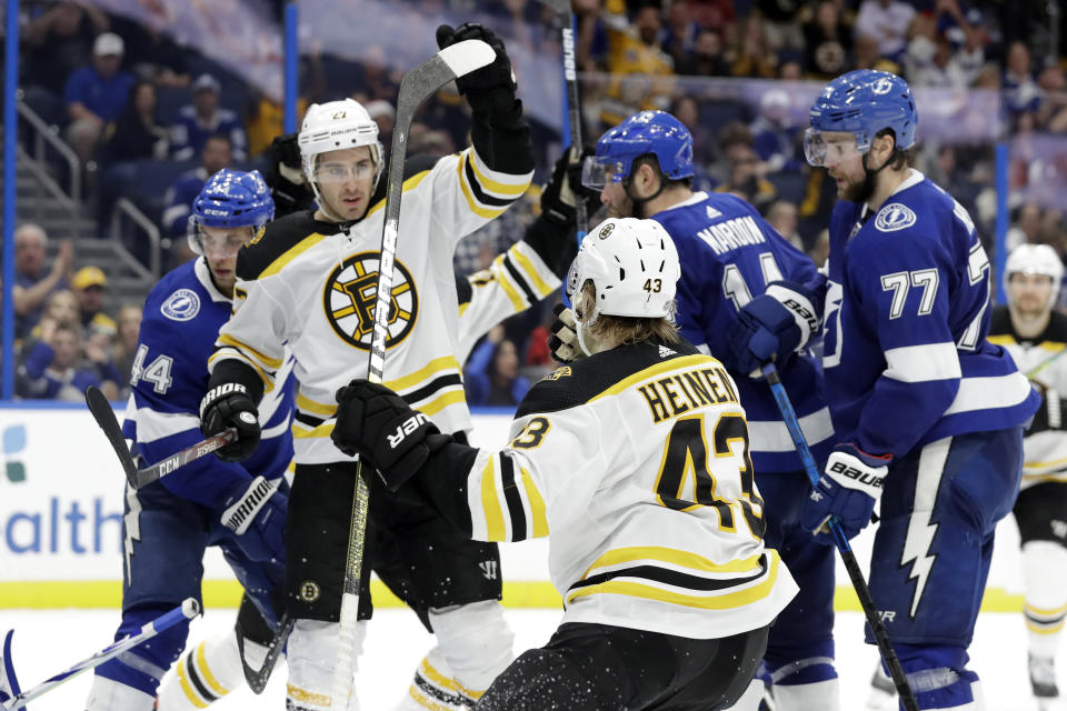 Boston Bruins defenseman John Moore (27) celebrates with center Danton Heinen (43) after scoring against the Tampa Bay Lightning during the third period of an NHL hockey game Thursday, Dec. 12, 2019, in Tampa, Fla. (AP Photo/Chris O'Meara)