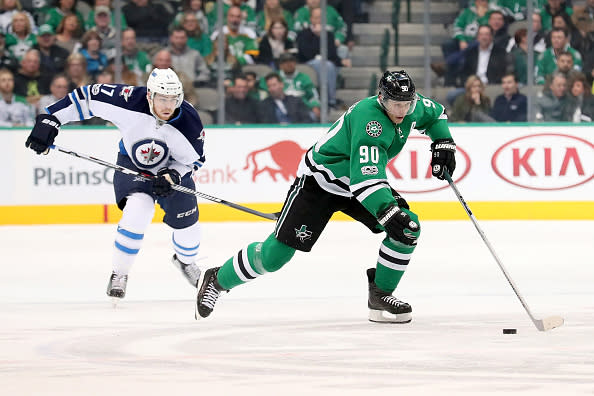 DALLAS, TX - FEBRUARY 02: Jason Spezza #90 of the Dallas Stars controls the puck against Adam Lowry #17 of the Winnipeg Jets in the first period at American Airlines Center on February 2, 2017 in Dallas, Texas. (Photo by Tom Pennington/Getty Images)