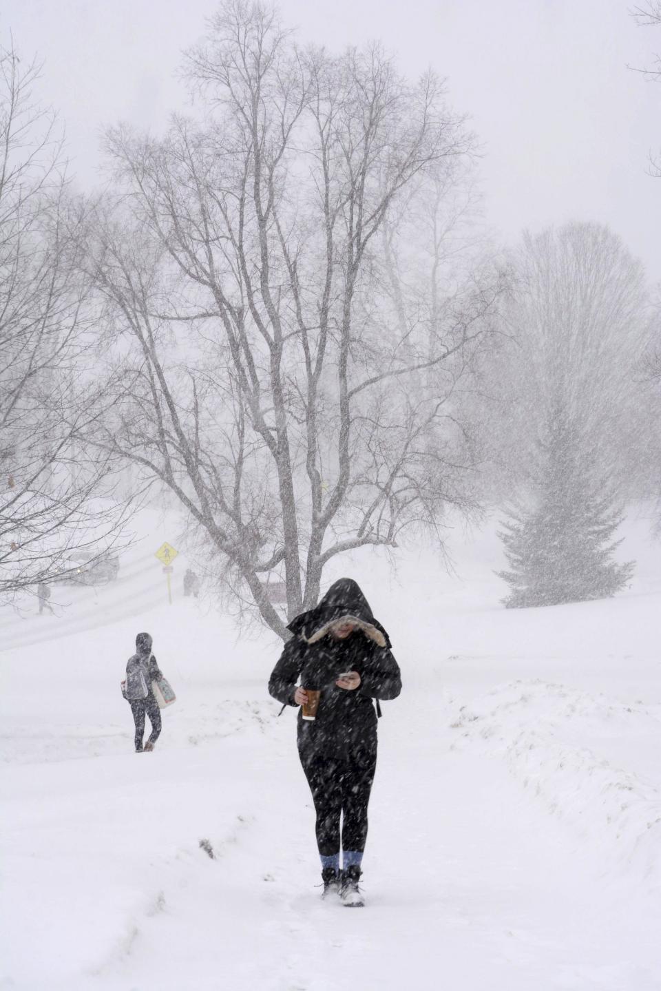 Williams College students trek across the snowy campus in Williamstown, Mass., during a winter storm which brought blizzard conditions and heavy snow to the region. Sunday, Feb. 12, 2017. (Gillian Jones/The Berkshire Eagle via AP)