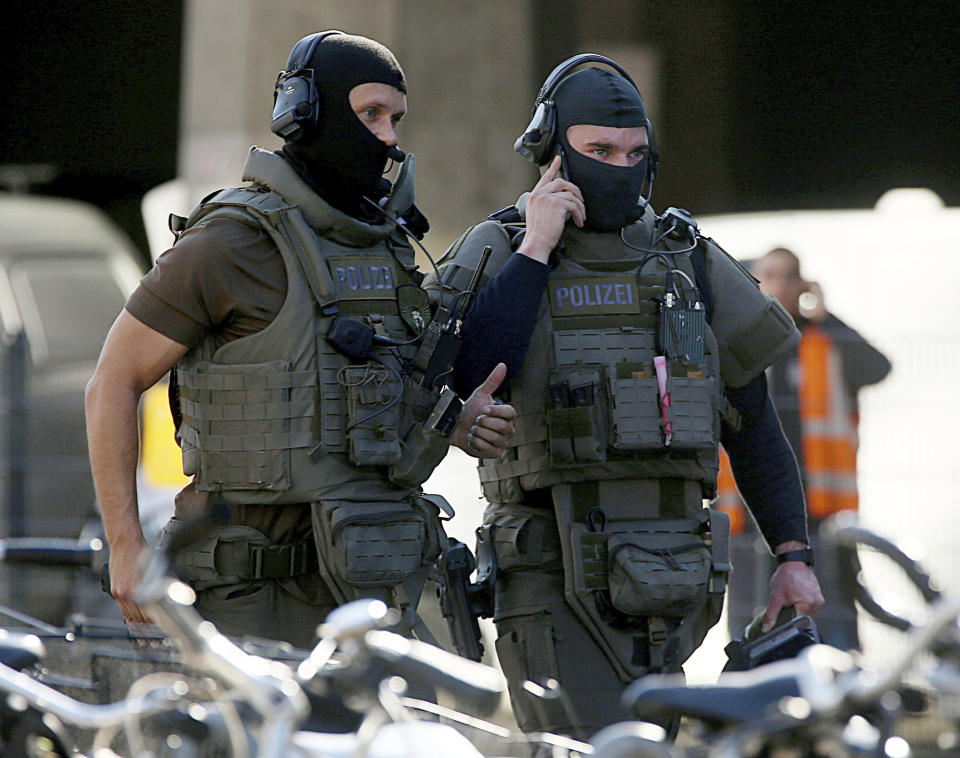 Special police operate outside the Cologne, western Germany, train station Monday, Oct. 15, 2018. Cologne police closed parts of the western German city’s main train station after a man took a woman hostage in a pharmacy inside. (Oliver Berg/dpa via AP)