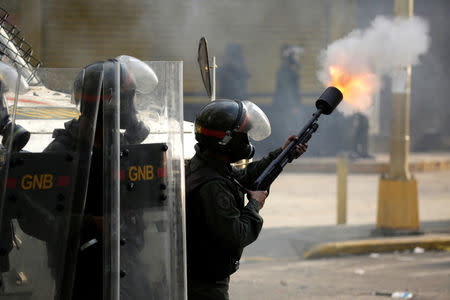 Riot police fire tear gas toward opposition supporters during clashes while rallying against Venezuela's President Nicolas Maduro in Caracas, Venezuela April 26, 2017. REUTERS/Marco Bello