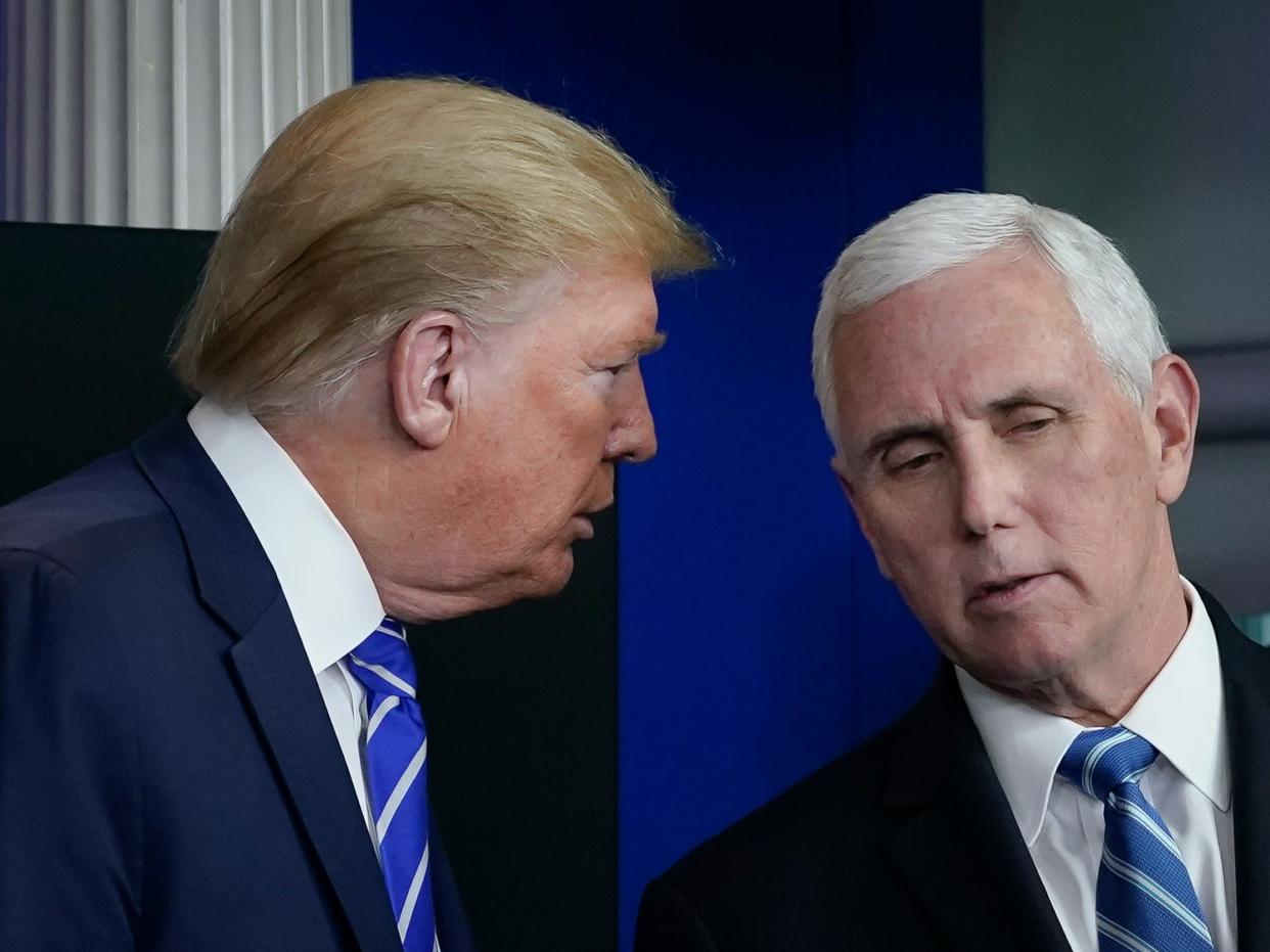 President Donald Trump speaks with Vice President Mike Pence during the daily briefing of the coronavirus task force at the White House on April 23, 2020 in Washington, DC.