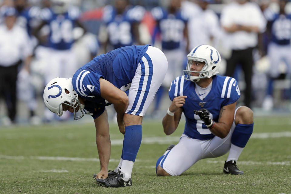 Indianapolis Colts kicker Adam Vinatieri (4) reacts to missing his second extra point of the game against the Tennessee Titans in the second half of an NFL football game Sunday, Sept. 15, 2019, in Nashville, Tenn. At right is holder Rigoberto Sanchez. (AP Photo/James Kenney)