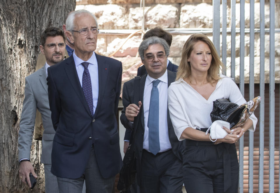 Members of Carlos Ghosn's defense team, lawyer Jean Yves Le Borgne, second left, Carlos Abou Jaoude, second right, and Jean Tamalet, left, leave the Justice Palace in Beirut, Lebanon, Friday, June 4, 2021. Ghosn was arrested in Japan in November 2018 on accusations of financial misconduct and was kept in solitary confinement for months without being allowed to speak with his wife. He fled to Lebanon a year later in a Hollywood-style escape that stunned the world. (AP Photo/Hassan Ammar)