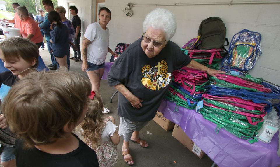 Sybil Hester hands out backpacks during the annual Back to School Bash Saturday morning, July 22, 2023, at the Cherryville Church of God.