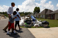 U.S. President Barack Obama greets a family as he tours houses in a flood-affected neighborhood in Zachary, Louisiana, U.S. August 23, 2016. REUTERS/Jonathan Ernst