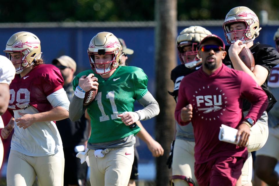 Florida State quarterback Brock Glenn (11) runs drills in preparation for the Orange Bowl NCAA college football game, Wednesday, Dec. 27, 2023, in Davie, Fla. Florida State is scheduled to play Georgia in the Orange Bowl Saturday at Hard Rock Stadium in Miami Gardens. (AP Photo/Lynne Sladky)