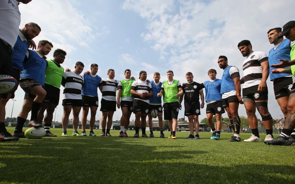 The Barbarians form a huddle following a training session - Getty Images Europe