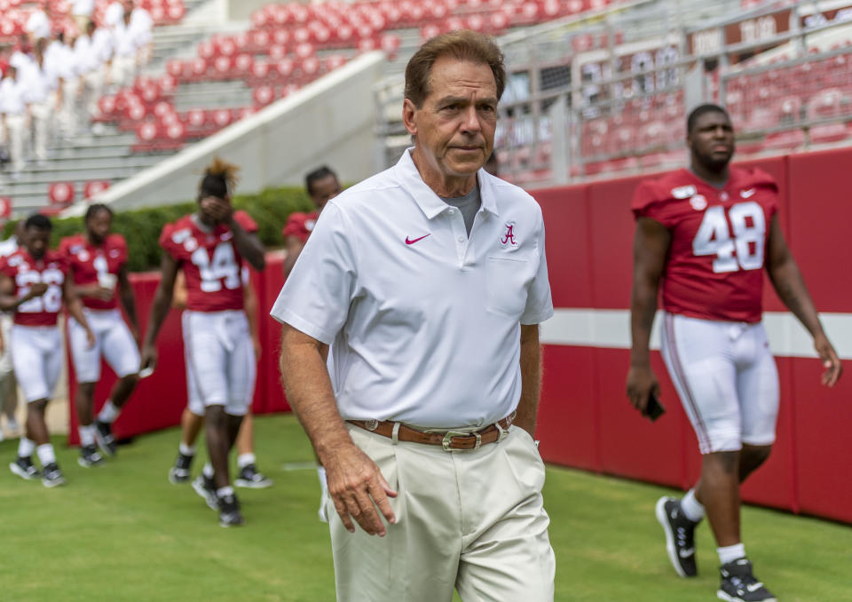 FILE - In this Aug. 3, 2019, file photo, Alabama head coach Nick Saban leaves the field after a team photo prior to Alabama's fall camp fan-day college football scrimmage,  in Tuscaloosa, Ala. Alabama is hardly immune to change, with an assemblage of new assistant coaches and the next wave of blue-chip prospects replacing the old ones. Two constants remain: coach Nick Saban and championship expectations. (AP Photo/Vasha Hunt)