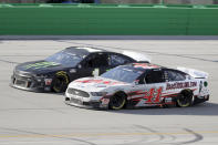 Kurt Busch (1) and Cole Custer (41) work during a NASCAR Cup Series auto race Sunday, July 12, 2020, in Sparta, Ky. (AP Photo/Mark Humphrey)