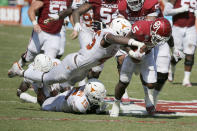 Texas linebacker Joseph Ossai (46) forces a fumble by Oklahoma running back T.J. Pledger (5) during an NCAA college football game in Dallas, Saturday, Oct. 10, 2020. (AP Photo/Michael Ainsworth)