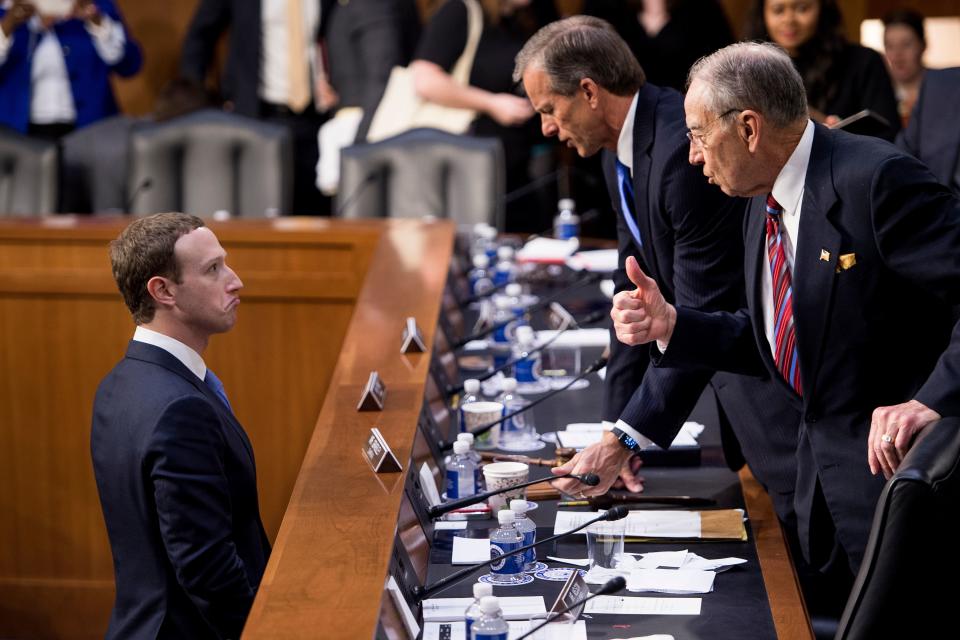 Facebook CEO Mark Zuckerberg (L) speaks with Senator John Thune (C), R-SD, and Senator Chuck Grassley (R), R-IA following a joint hearing of the Senate Commerce, Science and Transportation Committee and Senate Judiciary Committee on Capitol Hill April 10, 2018 in Washington, DC. Facebook chief Mark Zuckerberg took personal responsibility Tuesday for the leak of data on tens of millions of its users, while warning of an "arms race" against Russian disinformation during a high stakes face-to-face with US lawmakers. / AFP PHOTO / Brendan Smialowski        (Photo credit should read BRENDAN SMIALOWSKI/AFP/Getty Images)