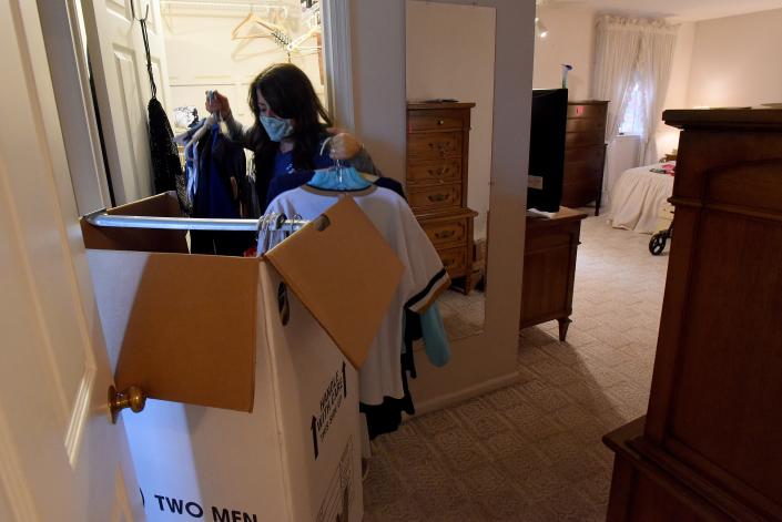 Jackie Wright, with Songbird Transitions, packs a wardrobe box while helping a client organize and pack to move. The organization works with clients who are downsizing their homes and some of their items are donated to groups like Fostering Further to help those in need.