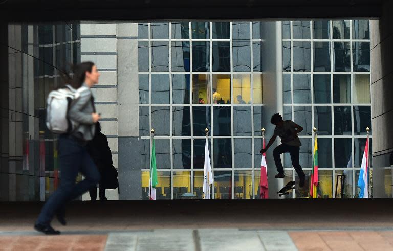 A skateboarder plays in front of the European Parliament in Brussels, on September 24, 2014