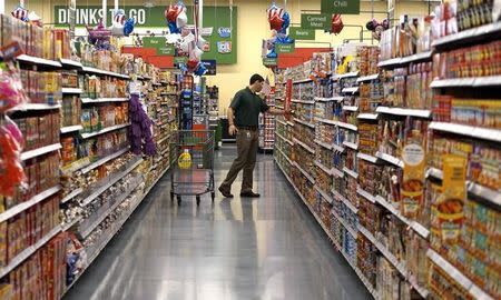 A customer shops at the Wal-Mart Neighborhood Market in Bentonville, Arkansas June 4, 2015. Wal-Mart will hold its annual meeting June 5, 2015. REUTERS/Rick Wilking