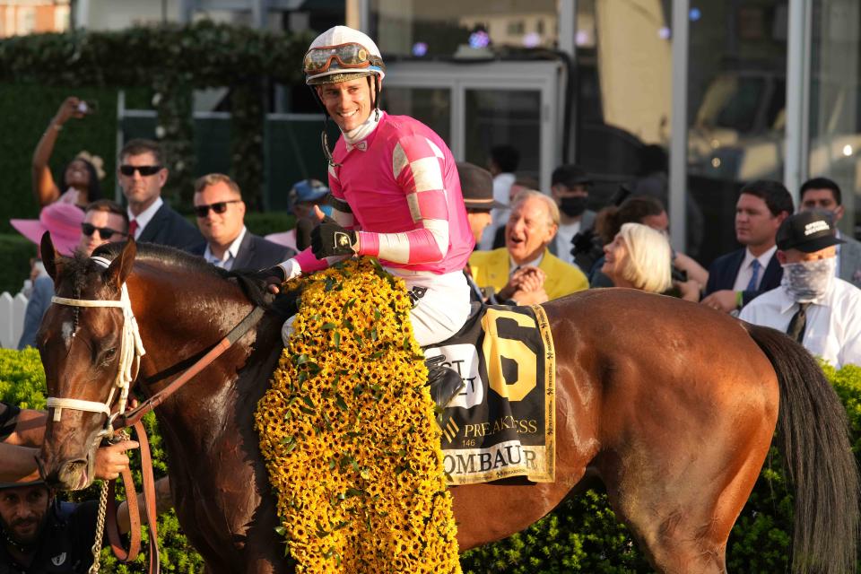 Jockey Flavien Prat and Rombauer celebrate in the Winners Circle after winning the 146th Preakness Stakes.