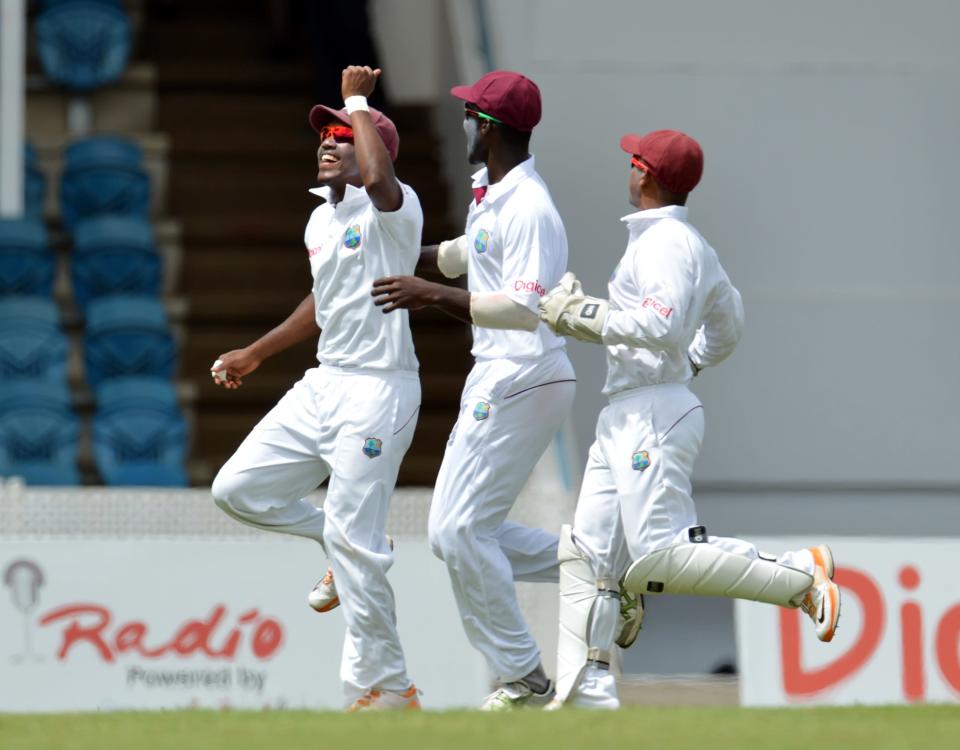 Darren Bravo (L) of the West Indies and teammates celebrate his catch of Australian batsman Matthew Wade during the second day of the second-of-three Test matches between Australia and West Indies April 16, 2012 at Queen's Park Oval in Port of Spain. AFP PHOTO/Stan HONDA (Photo credit should read STAN HONDA/AFP/Getty Images)