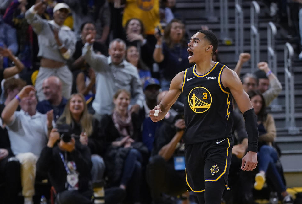 Golden State Warriors guard Jordan Poole (3) celebrates after scoring against the Memphis Grizzlies during the second half of Game 3 of an NBA basketball Western Conference playoff semifinal in San Francisco, Saturday, May 7, 2022. (AP Photo/Jeff Chiu)