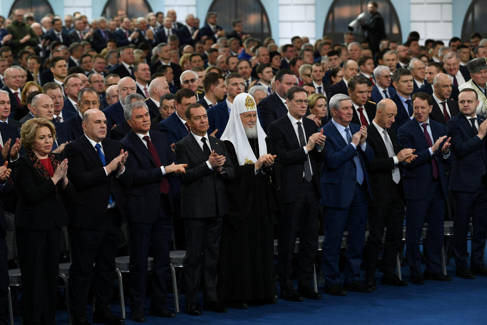 Participants applaud Putin's annual address.