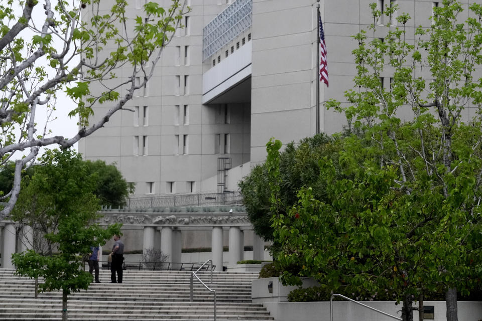 Security stands on the steps outside federal court waiting for Ippei Mizuhara, the former longtime interpreter for Los Angeles Dodgers star Shohei Ohtani, Friday, April 12, 2024, in Los Angeles. Mizuhara is charged with federal bank fraud, alleging that he stole more than $16 million from the Japanese sensation to cover gambling bets and debts, federal authorities said. (AP Photo/Damian Dovarganes)