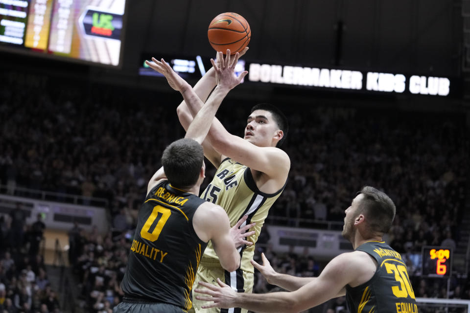 Purdue center Zach Edey (15) shoots over Iowa forward Filip Rebraca (0) and guard Connor McCaffery (30) during the second half of an NCAA college basketball game in West Lafayette, Ind., Thursday, Feb. 9, 2023. Purdue defeated Iowa 87-73. (AP Photo/Michael Conroy)