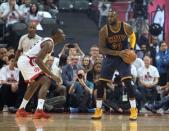 May 23, 2016; Toronto, Ontario, CAN; Cleveland Cavaliers forward LeBron James (23) looks to play a ball as Toronto Raptors center Bismack Biyombo (8) tries to defend in game four of the Eastern conference finals of the NBA Playoffs at Air Canada Centre. Mandatory Credit: Nick Turchiaro-USA TODAY Sports