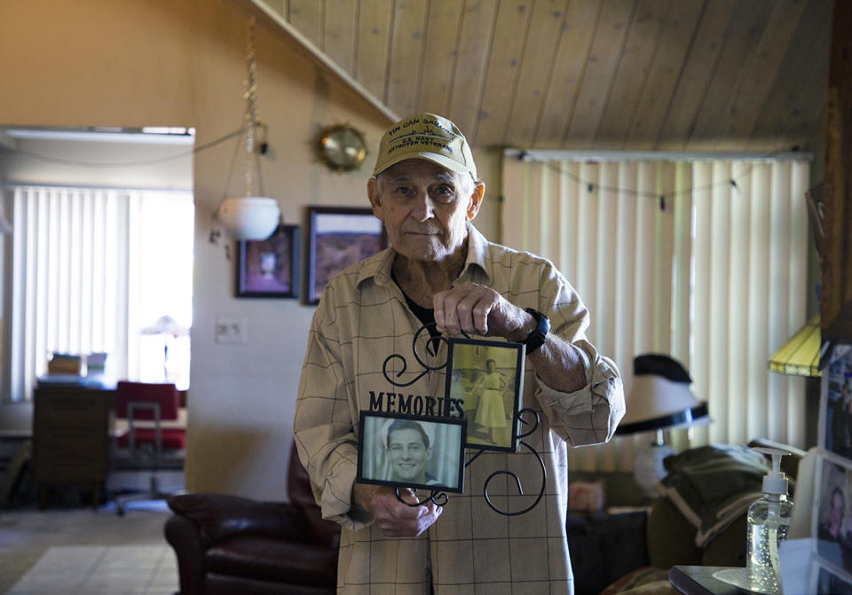 Vincent Randazzo holds a frame containing photos of him and his wife, Rose Violet Randazzo. (Mariana Henninger / NBC News)