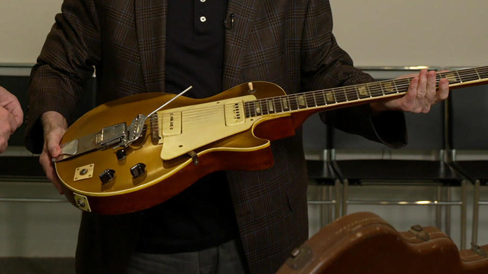 Gene Paul holds his father's prototype for the Gibson Goldtop electric guitar.   / Credit: CBS News