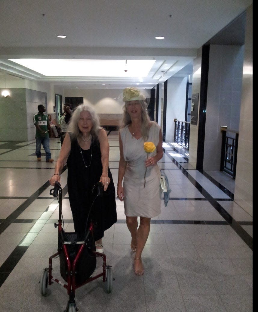 Antigone Barton, right, and her mother walking down the courthouse corridor for Barton's wedding.