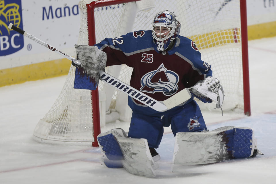 Colorado's goalie Hunter Miska (32) blocks the puck with his stick in the first period of an NHL hockey game against the Minnesota Wild, Sunday, Jan. 31, 2021, in St. Paul, Minn. (AP Photo/Stacy Bengs)