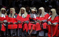 <p>A senior judge uses a fan to shield her face from the sun as she sits with others at the inauguration ceremony of President Emmerson Mnangagwa in the capital Harare, Zimbabwe Friday, Nov. 24, 2017. (Photo: Ben Curtis/AP) </p>