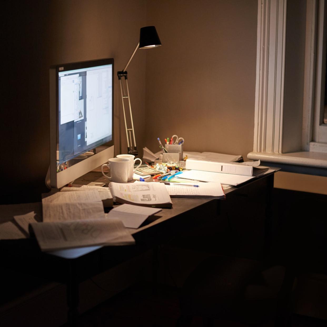 Cropped shot of a pc and textbooks on a desk in a study