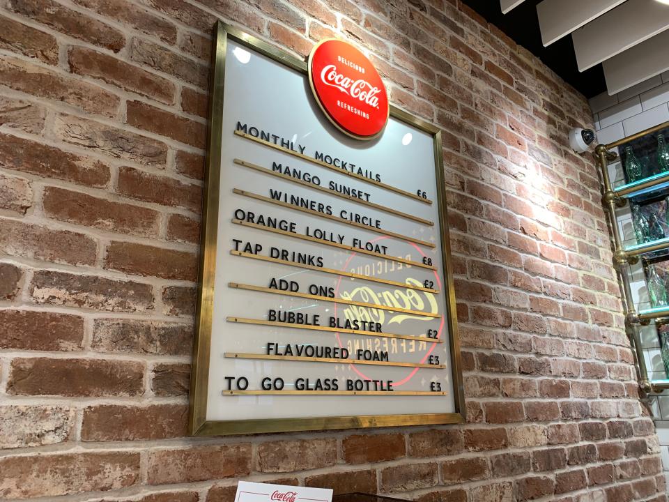 The menu behind the bar in the Coca-Cola London store.