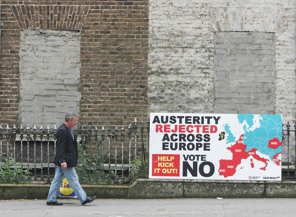 A man walks past a sign against the European Fiscal Treaty in Dublin Wednesday May 30, 2012 ahead of Thursdays referendum. Ireland is the only country in Europe holding a referendum on the treaty as it is obliged to put major EU reforms to the public test according to the Constitution. (AP Photo/Niall Carson/PA) UNITED KINGDOM OUT